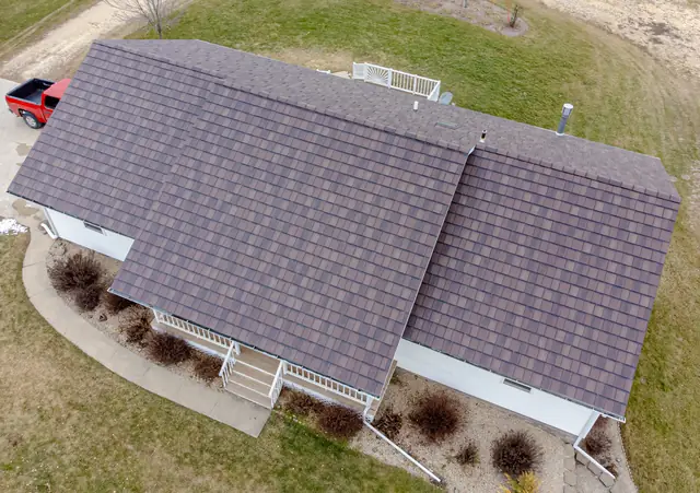 Aerial view of a house with a shingle roof