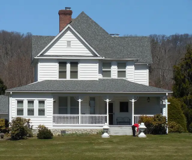 Two-story New England style house with a gray shingle roof